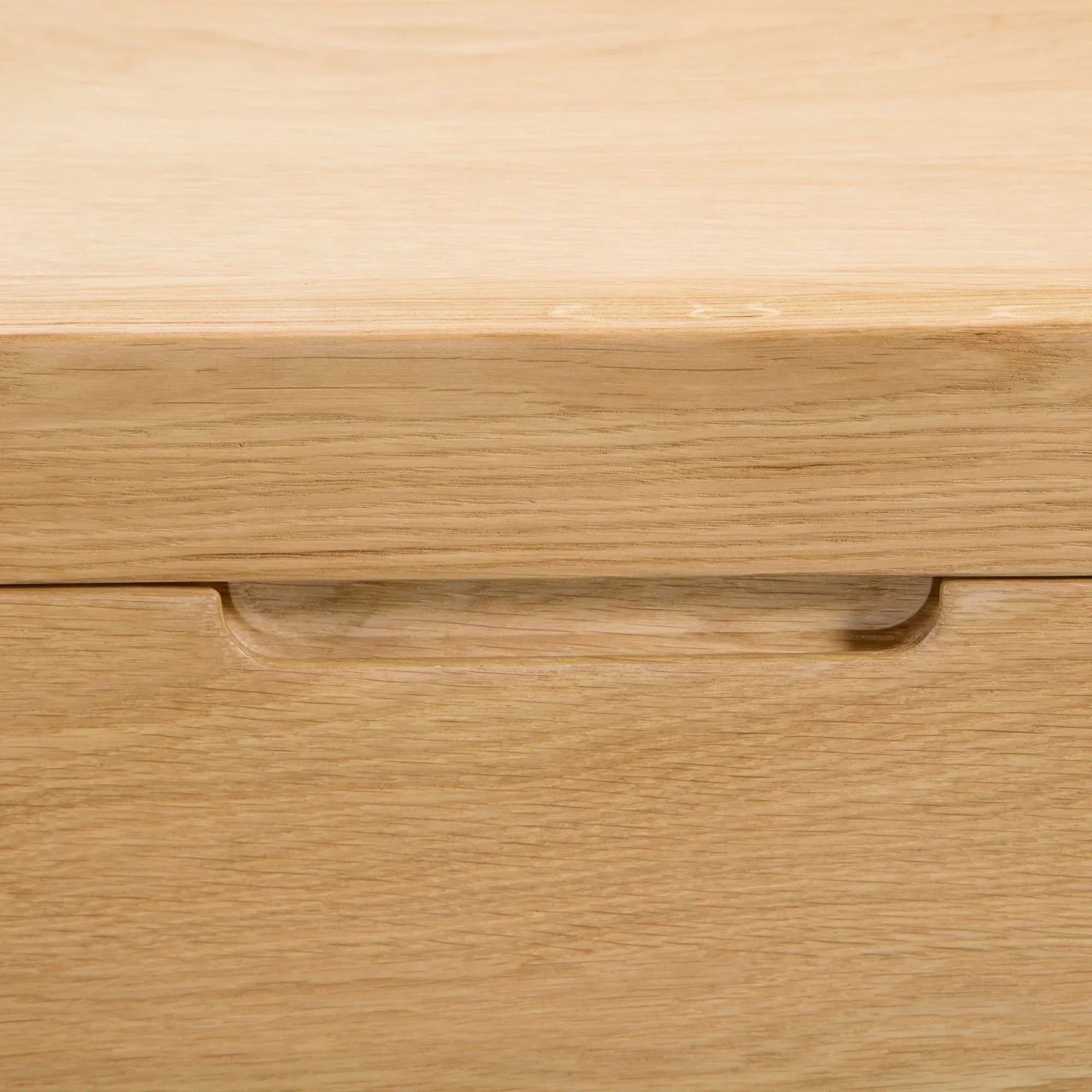 Oak chest of drawers close-up showing integrated handle detail on drawer front