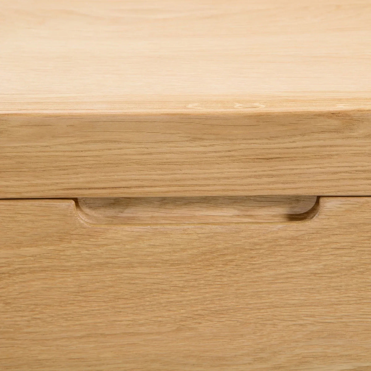 Oak chest of drawers close-up showing integrated handle detail on drawer front
