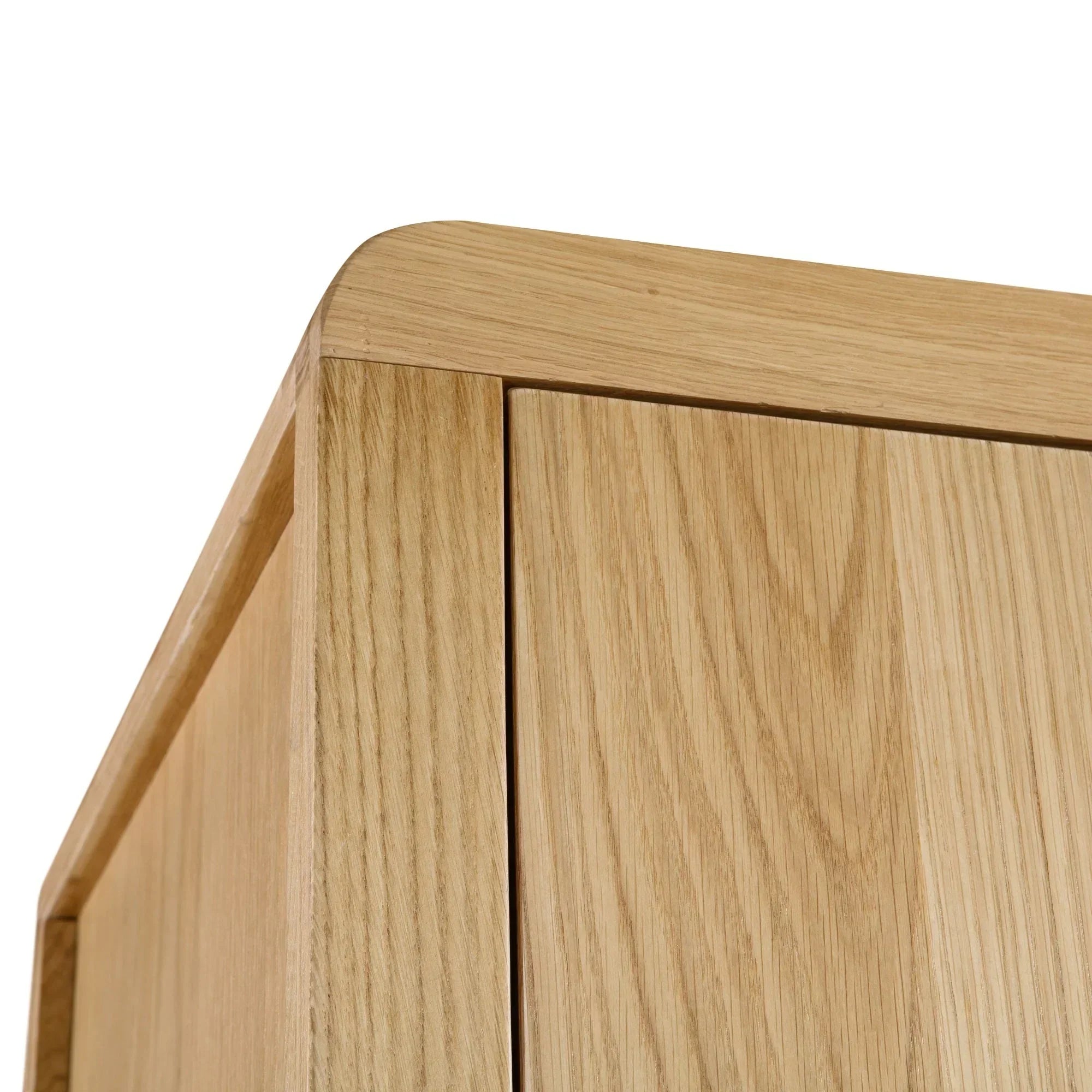 Closeup of oak wardrobe corner showing smooth curved edge and wood grain detail