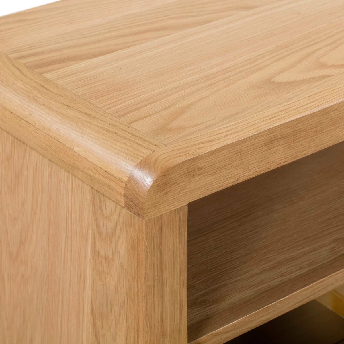 Oak TV unit close-up showing curved edge and visible wood grain