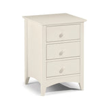 Cream wood bedside table with three drawers and rounded handles, angled front view