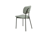 Grey dining chair with padded seat, curved backrest and black metal legs, side view