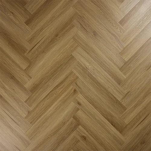 Chestnut wood effect laminate flooring in a herringbone pattern close up