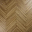 Chestnut wood effect laminate flooring in a herringbone pattern close up