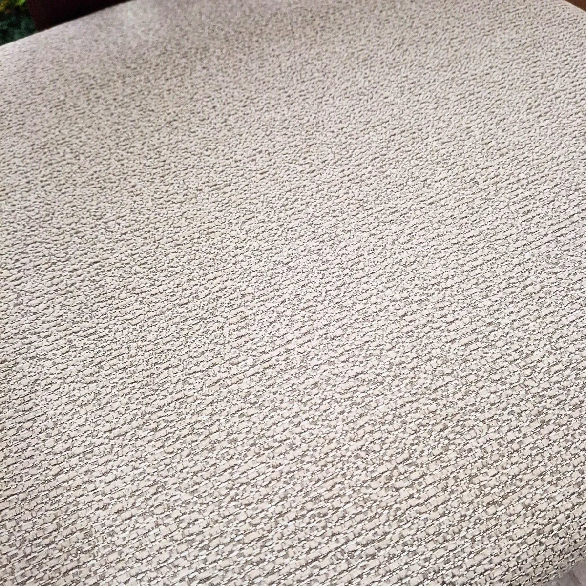 Closeup of Clara barstool seat with textured beige fabric upholstery