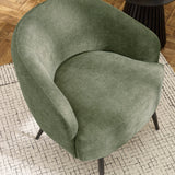 Top angled view of green fabric accent chair showing round seat and curved back on patterned rug.