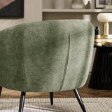 Close-up detail of fabric texture and seam on backrest of green accent chair with black legs on rug.