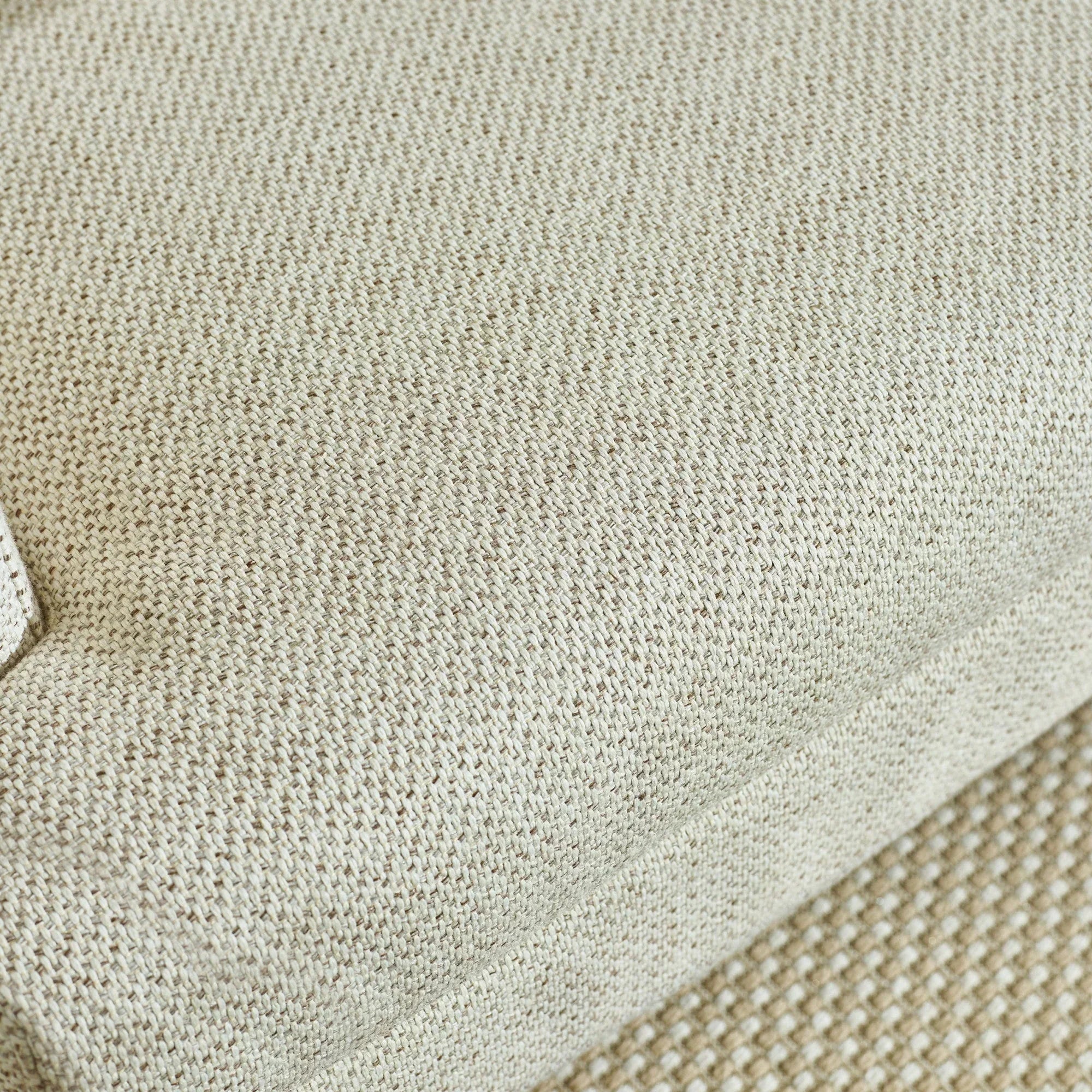 Beige sofa cushion close-up showing textured woven fabric detail