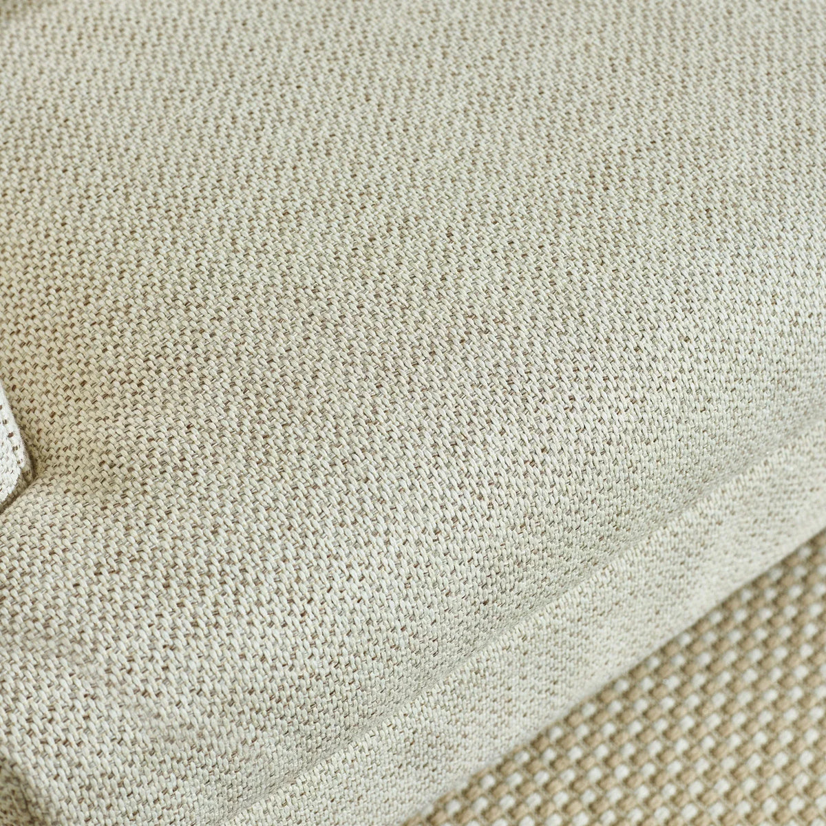 Beige sofa cushion close-up showing textured woven fabric detail