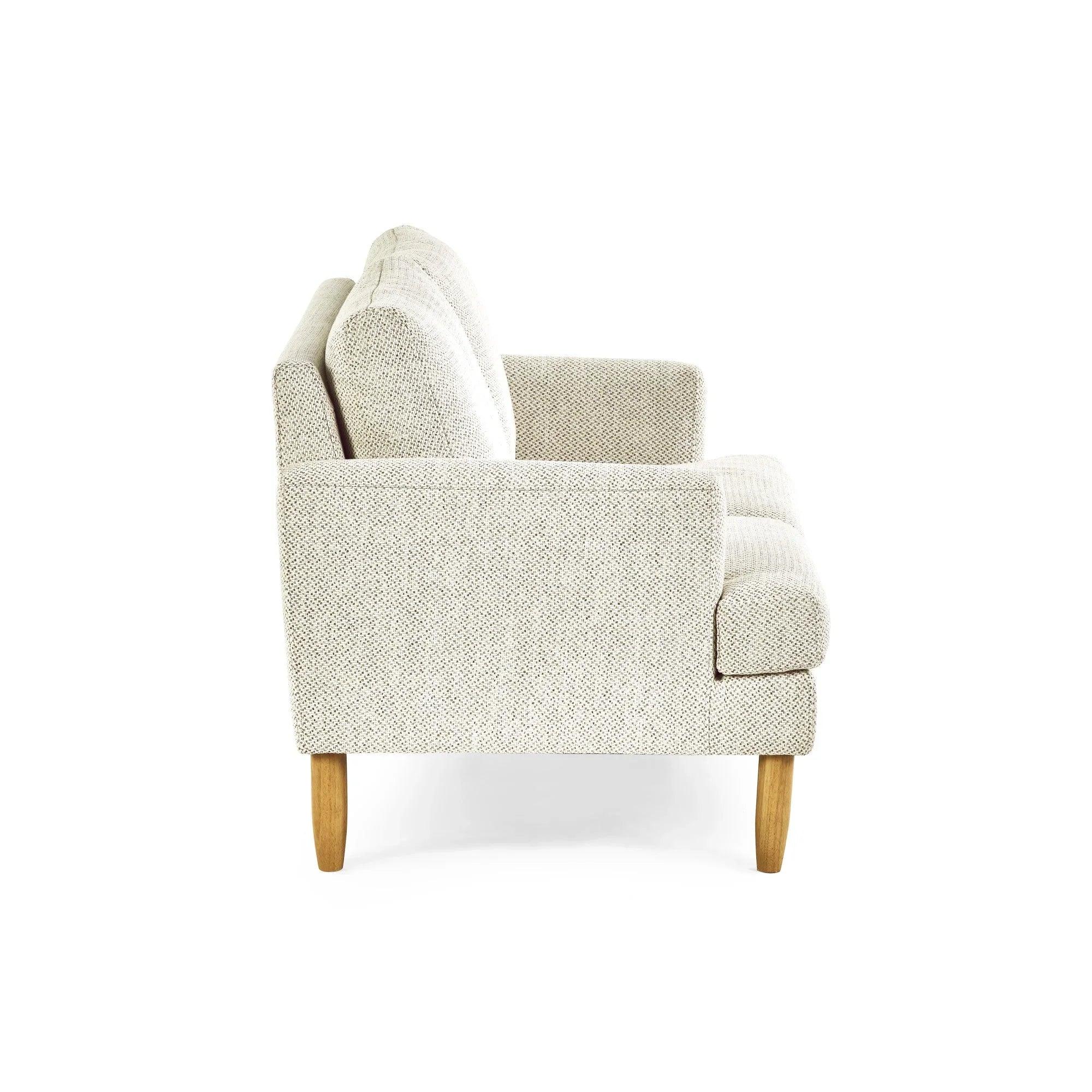 Side view of light fabric sofa with wooden legs and tufted seat cushions