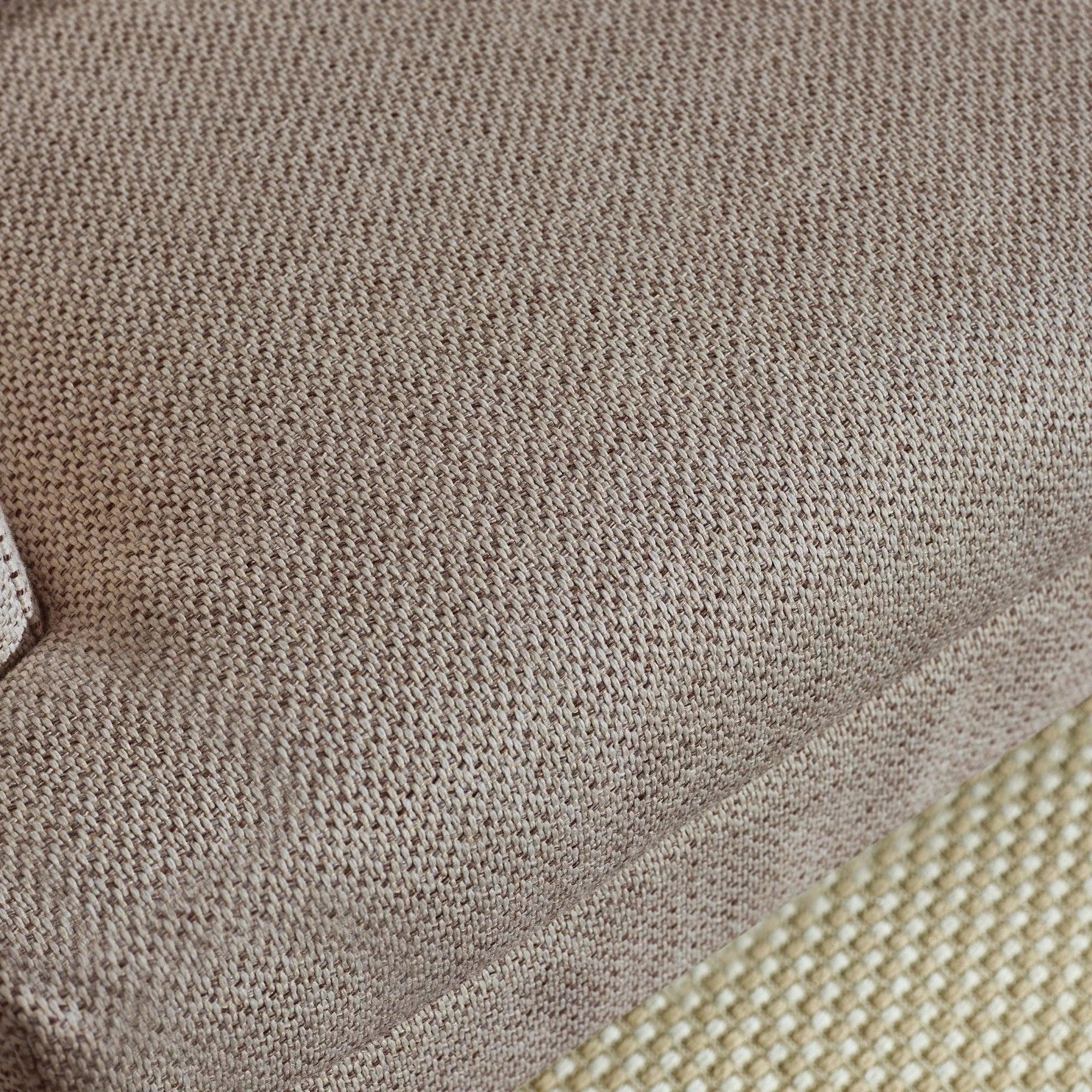 Close up of beige fabric sofa cushion with textured weave detail