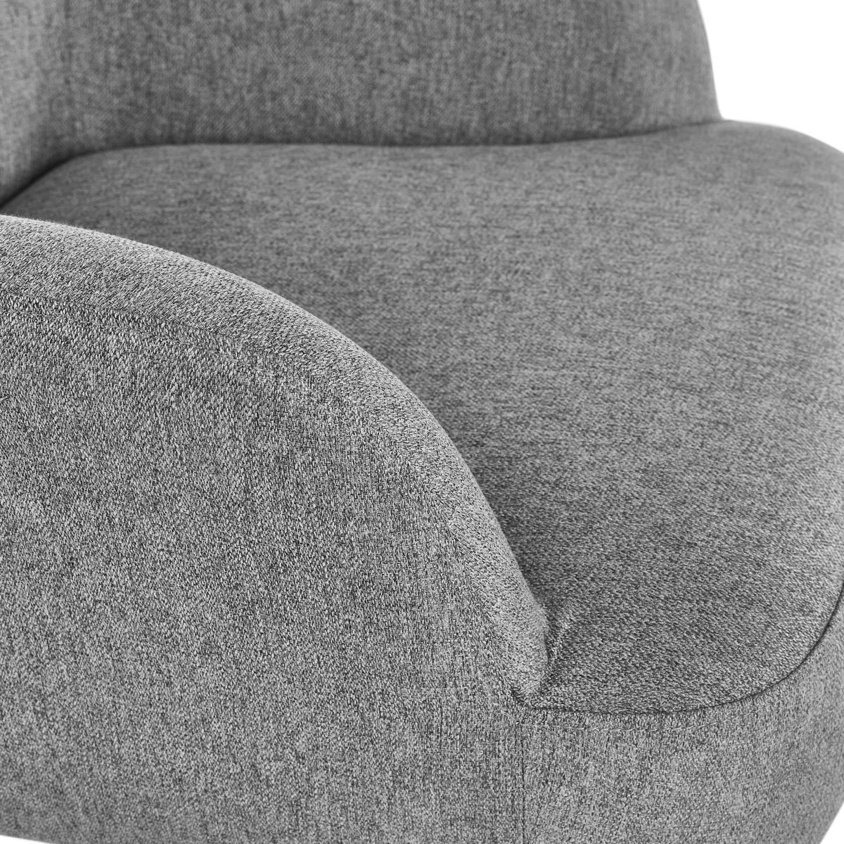Close detail of grey fabric accent chair armrest and seat