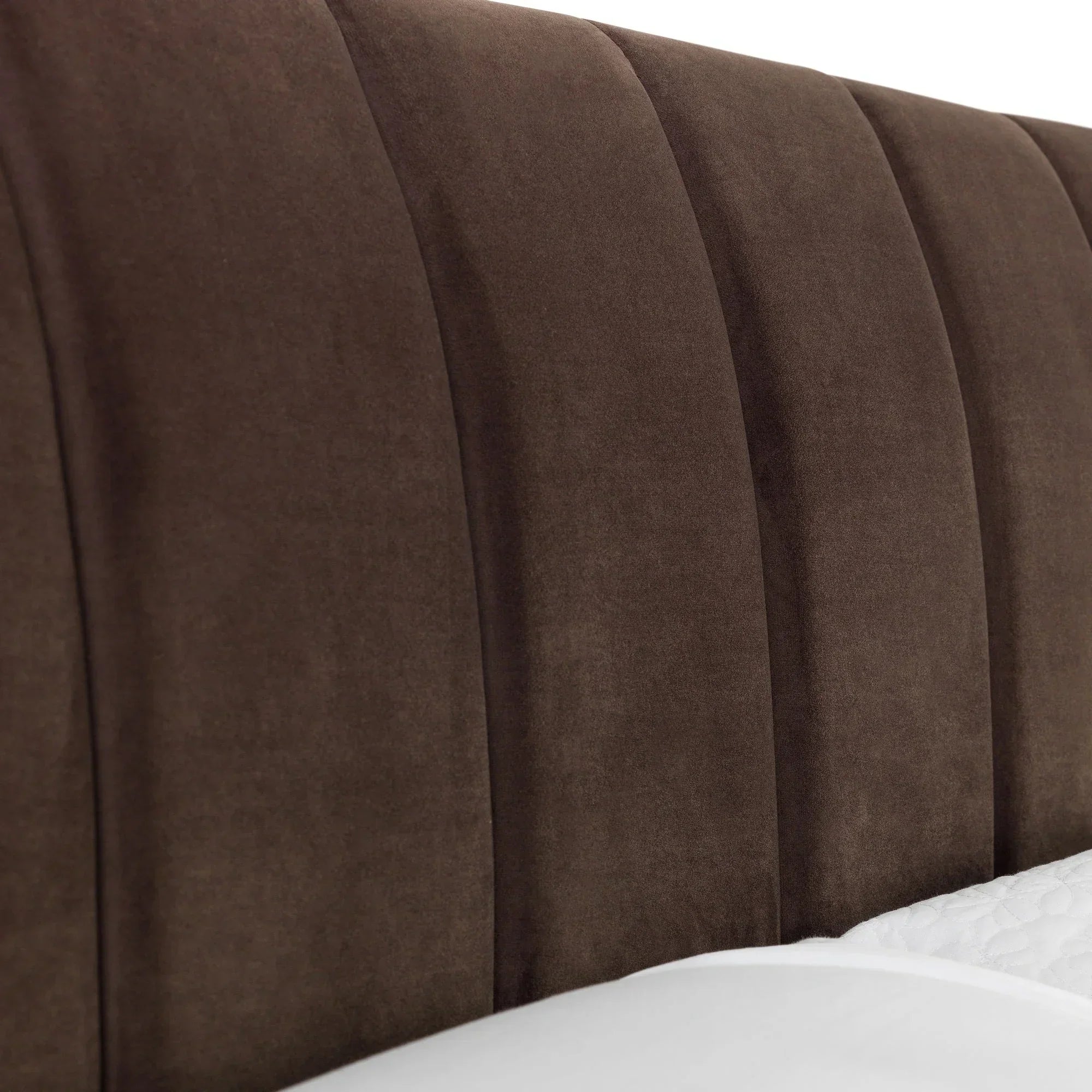 Close-up of truffle velvet king bed headboard with vertical panel detailing