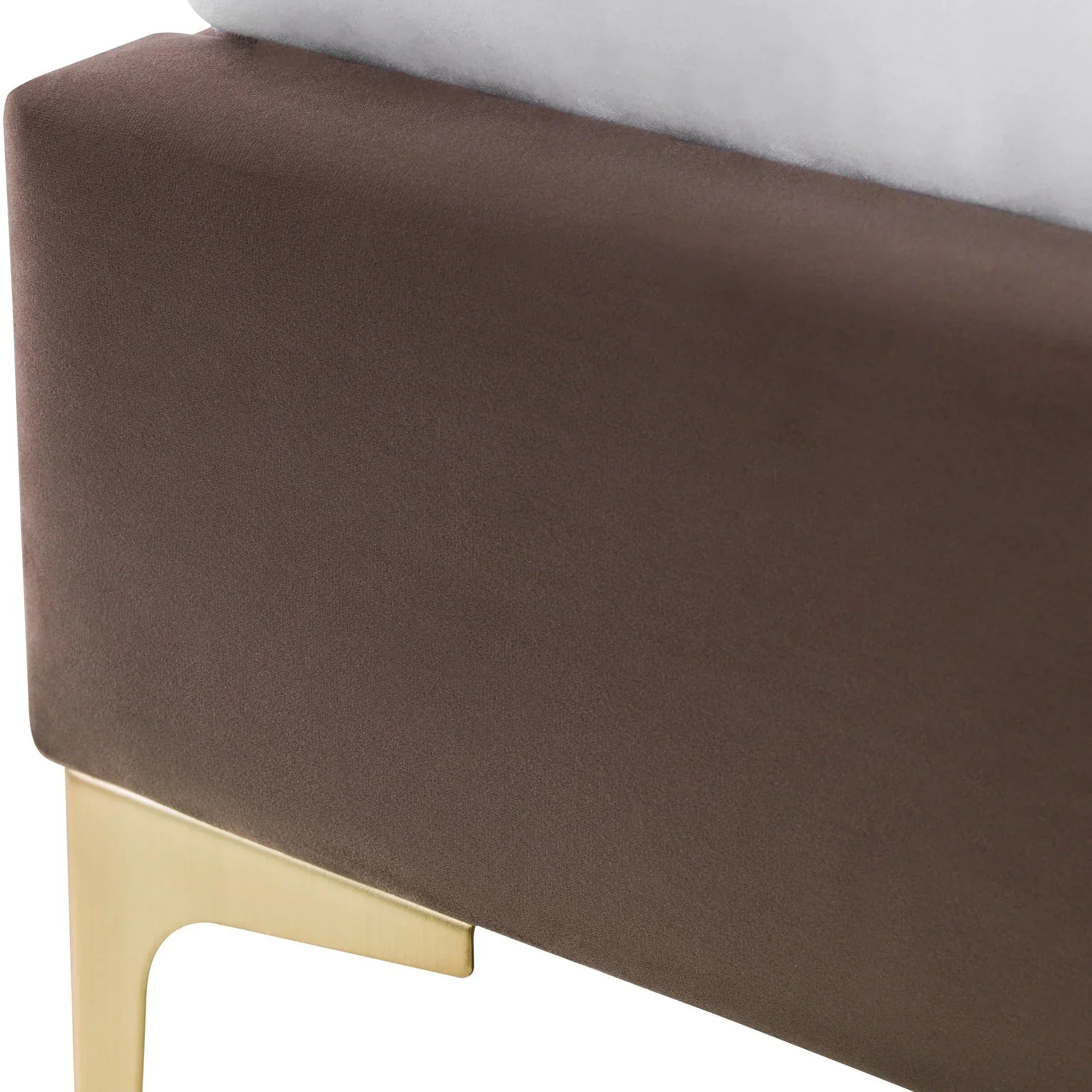 Truffle velvet king bed corner with gold metal leg and soft upholstery detail