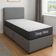 A single bed with a gray upholstered headboard and base, featuring a white quilted mattress topper. The side of the mattress shows the brand name 'Deep Sleep' in white text.