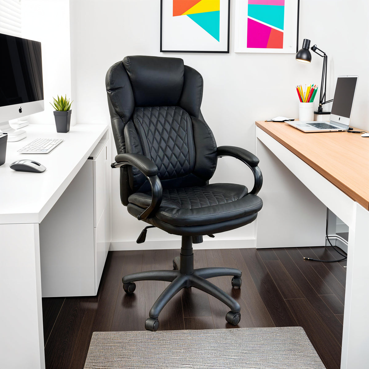 Black quilted leather executive office chair with padded arms between two office desks.