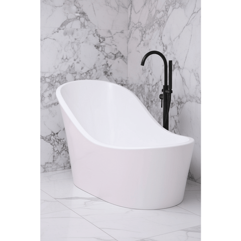 White freestanding bathtub with a black faucet against a marble wall.