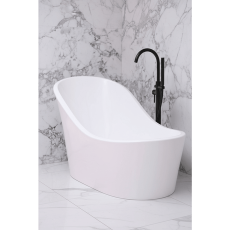 White freestanding bathtub with a black faucet against a marble wall.