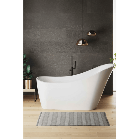 Modern bathroom with a freestanding white bathtub against a dark gray wall.