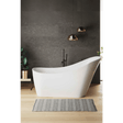 Modern bathroom with a freestanding white bathtub against a dark gray wall.