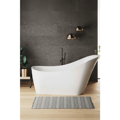 Modern bathroom with a freestanding white bathtub against a dark gray wall.