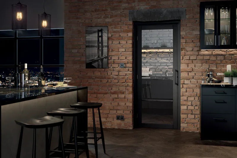 Dark charcoal glazed 4 panel interior door with black frame in modern kitchen setting