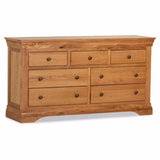 Oak wide chest of drawers with seven compartments and bronze handles, angled front view
