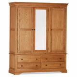 Oak triple wardrobe with four drawers and mirrored door front view