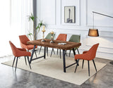 Wood dining table with black metal legs, orange and green upholstered chairs, modern room