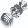 Brushed metal door knob with fluted round design, shown at an angle