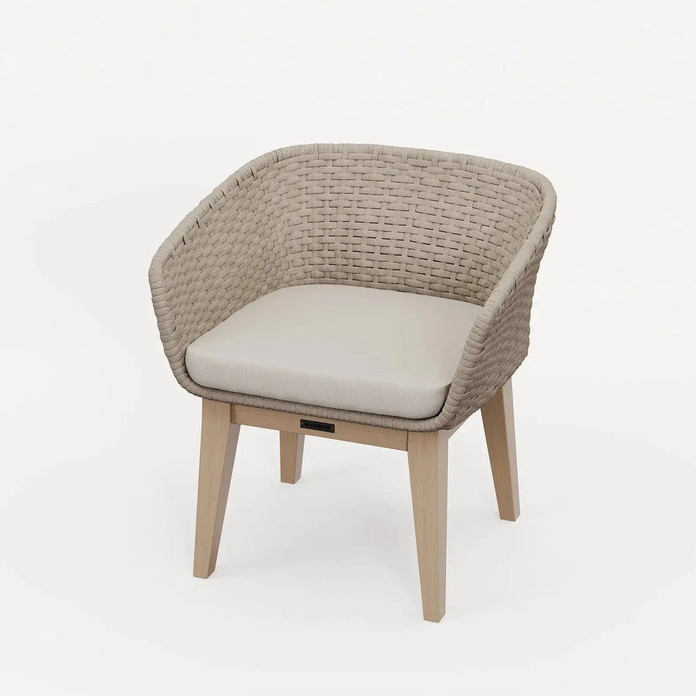 Beige woven accent chair with curved back and light wood legs, upholstered seat cushion
