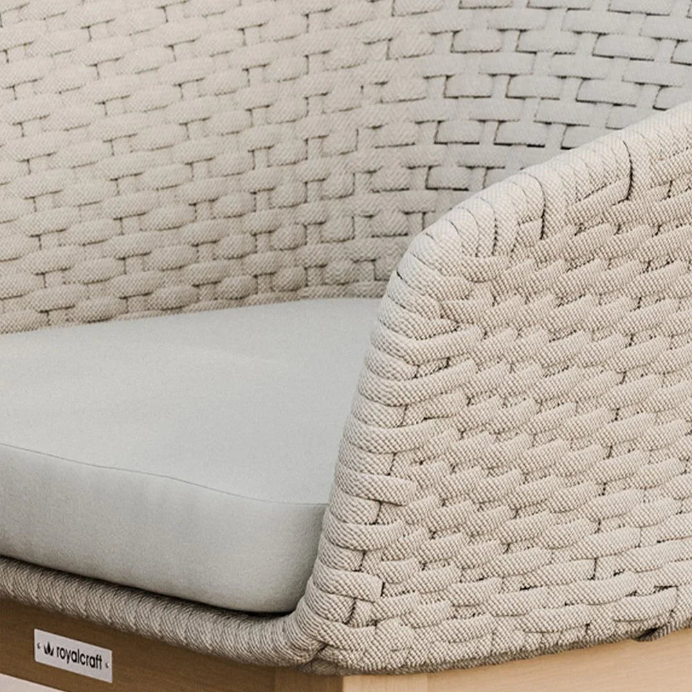 Close up of beige woven outdoor sofa arm and seat cushion