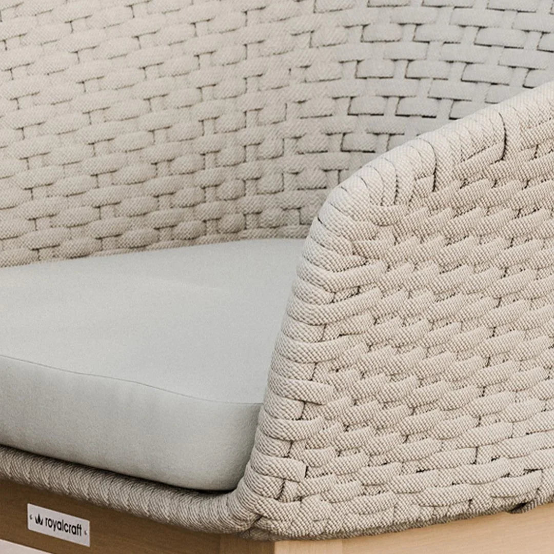 Close up of beige woven outdoor sofa arm and seat cushion