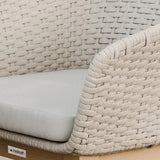 Close up of beige woven outdoor sofa arm and seat cushion