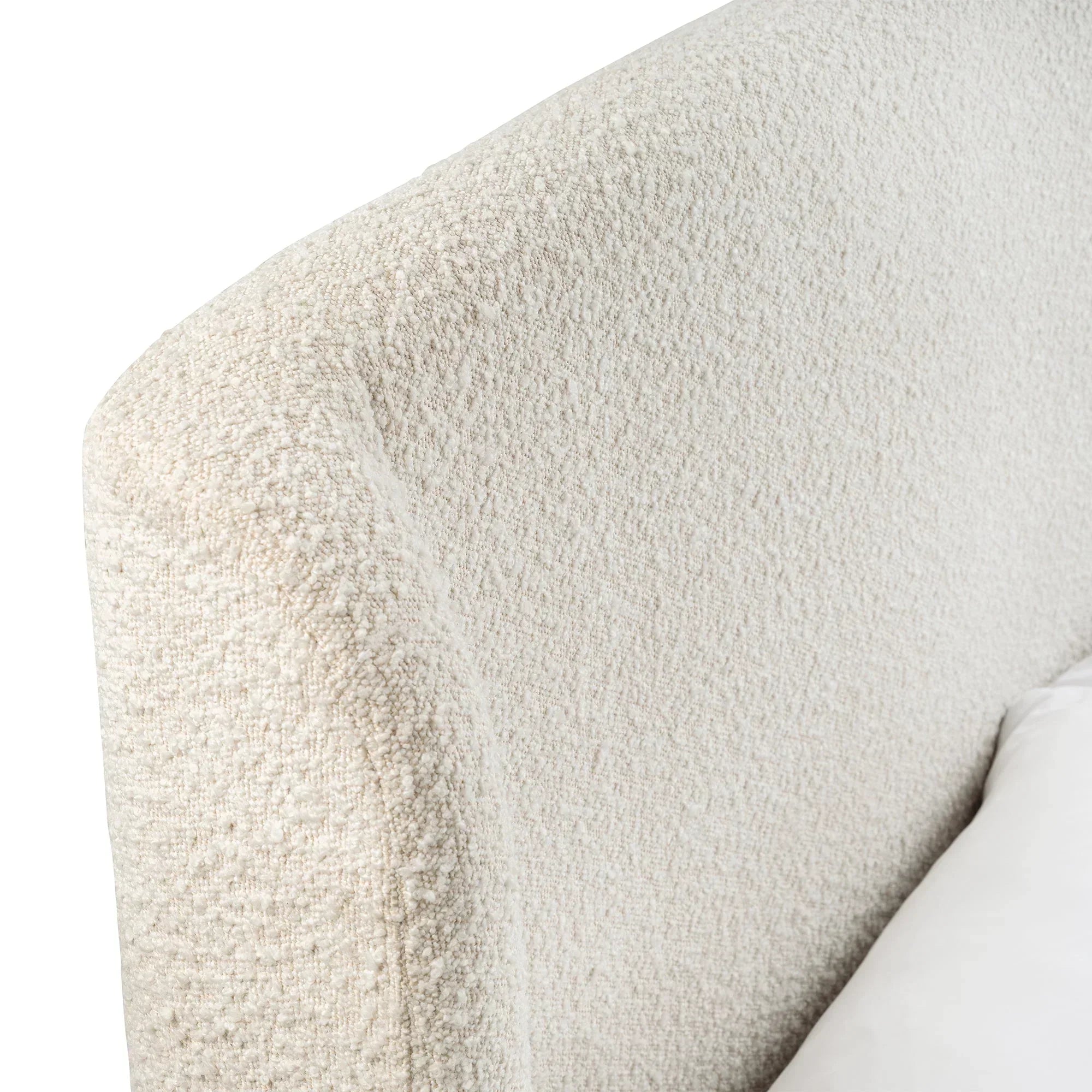 Detail of ivory boucle double bed headboard with textured fabric upholstery