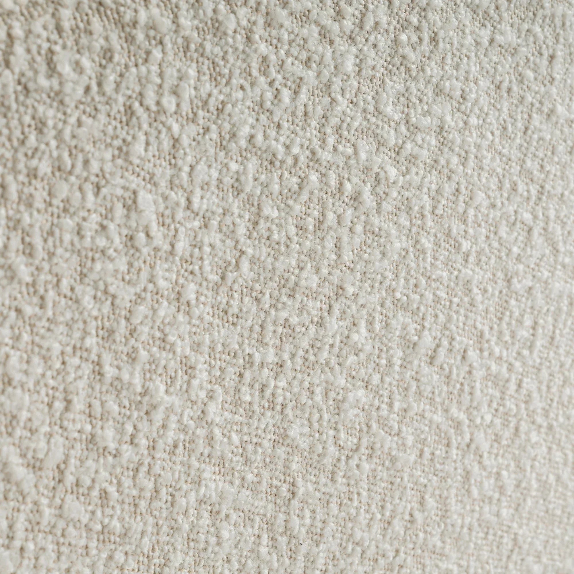 Ivory boucle fabric texture close-up on double bed upholstery