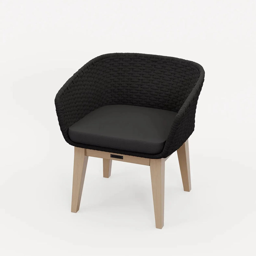 Black woven dining chair with cushioned seat and light wood legs on white background