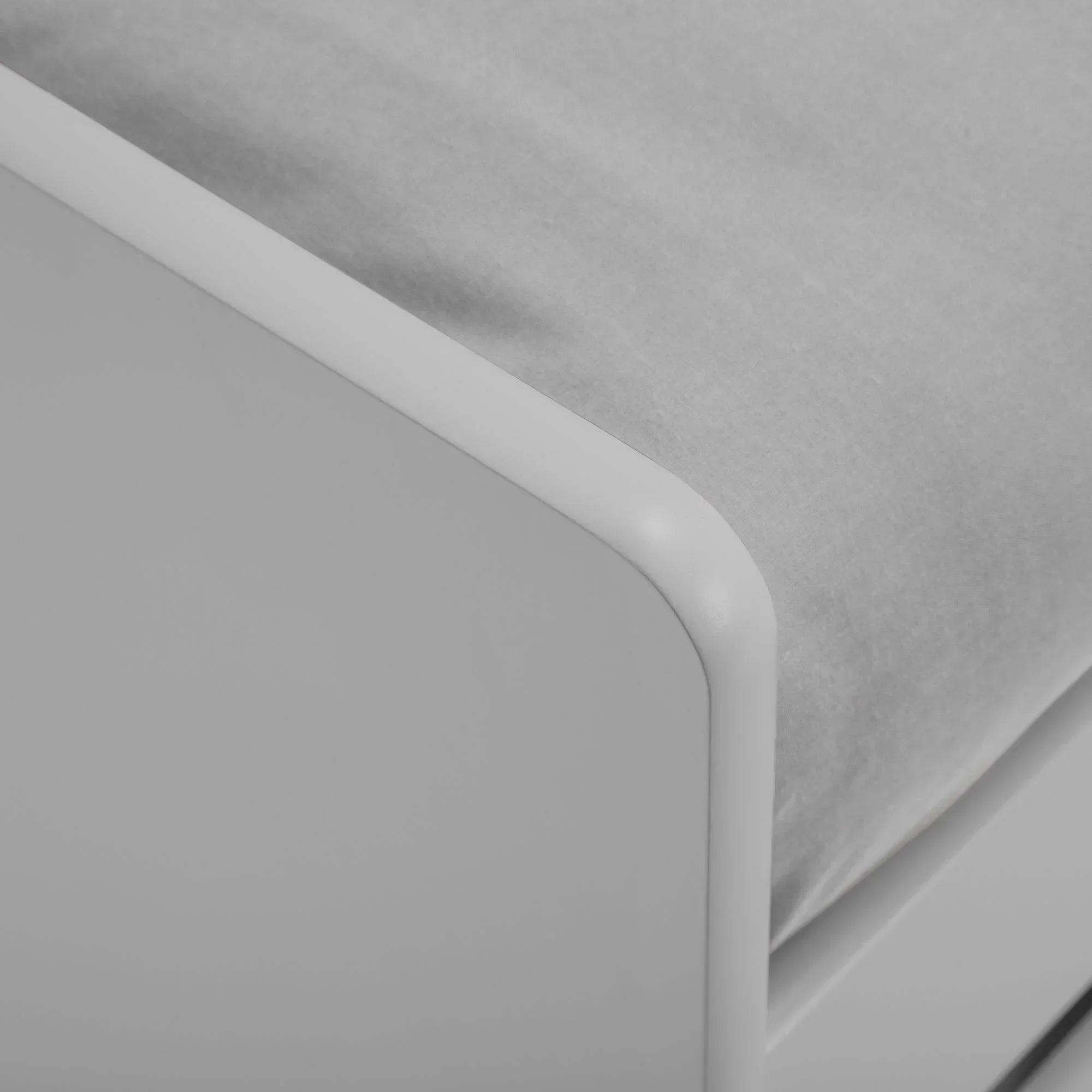 Closeup of dove grey single daybed corner with fabric mattress and smooth frame