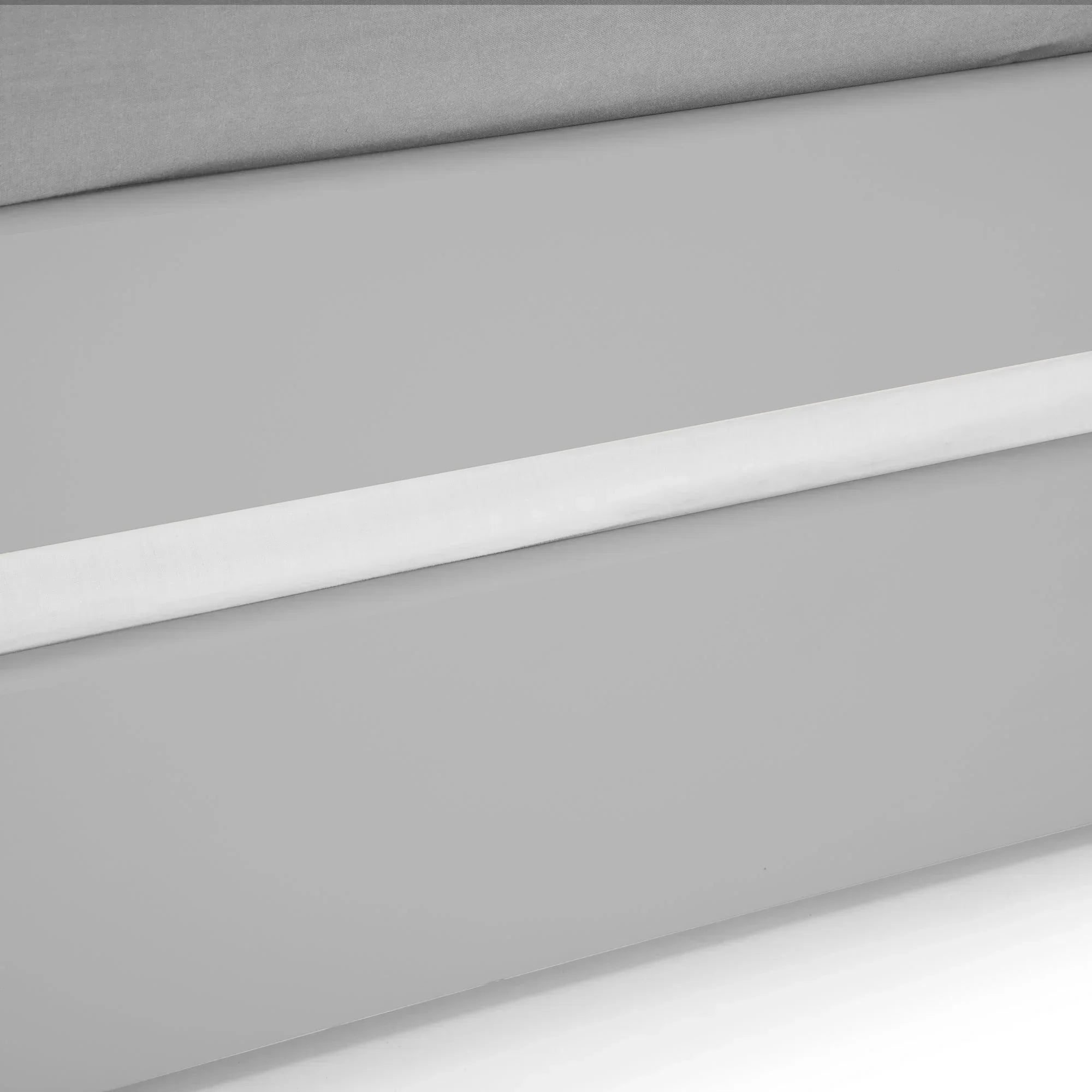 Detail of dove grey single daybed frame with clean lines and flat front panel