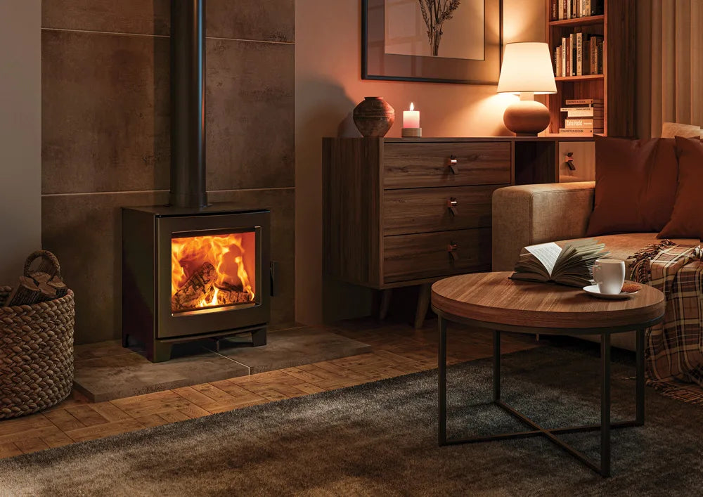 Stylish wood burning stove in a cozy living room setting with warm lighting and comfortable furnishings.