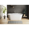 Modern bathroom with a freestanding bathtub, plants, and a gray wall.
