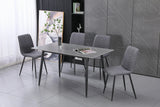 Modern grey dining table set with four upholstered chairs in contemporary room