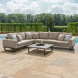 Large beige corner outdoor sofa set with cushions and coffee table on a patio