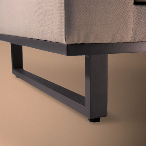 Close-up of corner sofa metal leg with beige fabric upholstery
