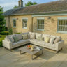Latte corner group outdoor sofa set with cushions and coffee table on stone patio