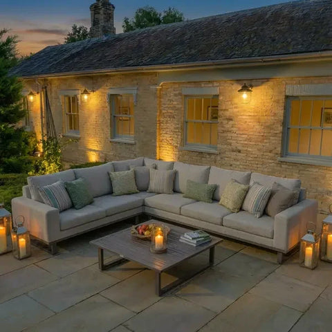 Latte corner group sofa with cushions and coffee table on patio at dusk