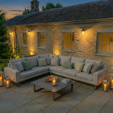 Latte corner group sofa with cushions and coffee table on patio at dusk