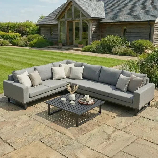 Large corner group outdoor sofa in grey fabric with coffee table on patio