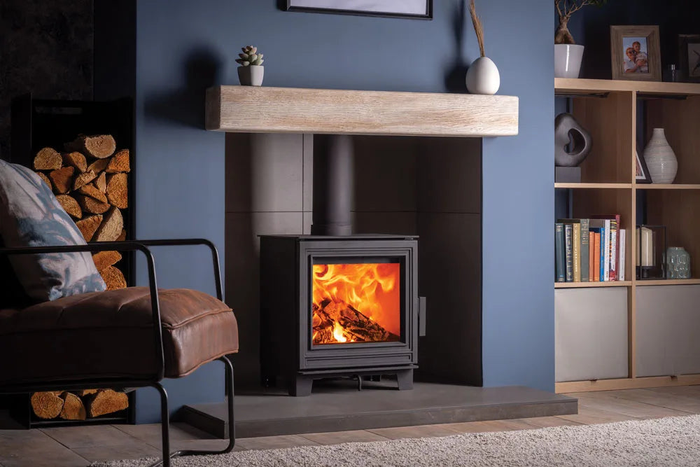 Eton wood burning stove with a warm fire, set against a stylish living room backdrop.