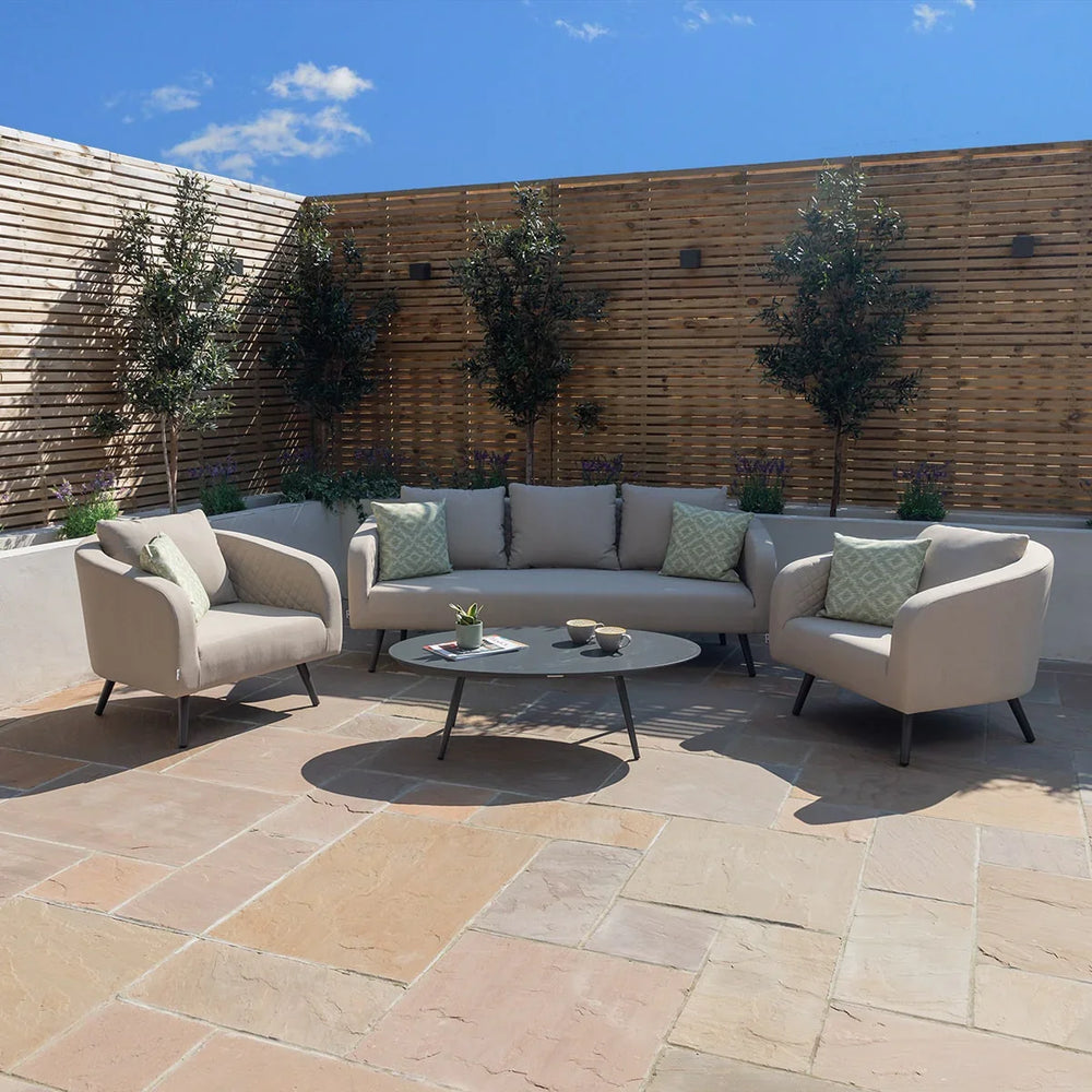 Outdoor sofa set with beige cushions and coffee table on stone patio